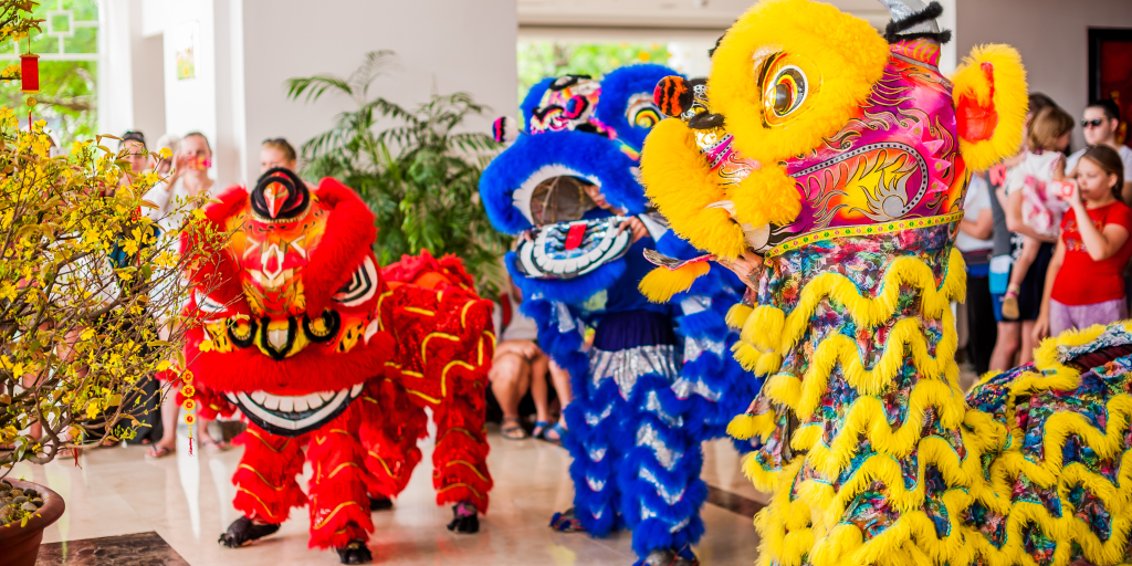 Celebrating Lunar New Year in the Classroom - the picture is of three Lions for a Lion Dance performance. One is red, one is blue, and one is yellow.