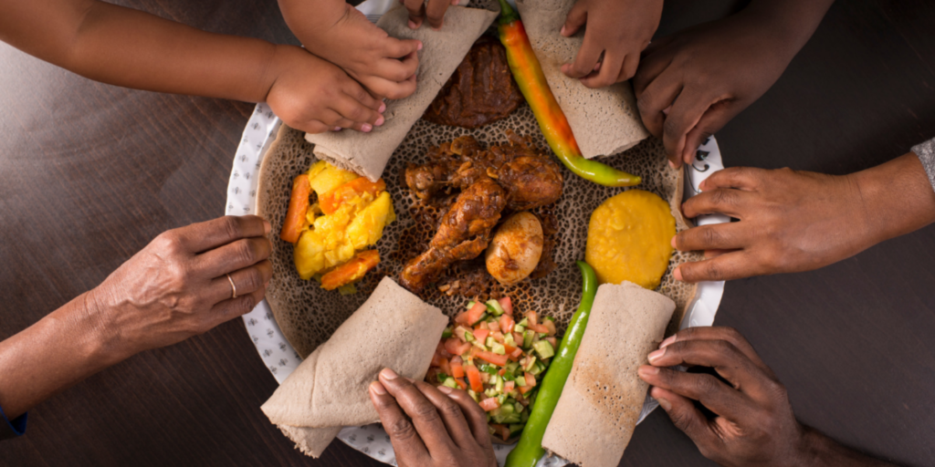 5 Easter Celebrations Around the Globe: Embracing Diversity and Tradition: This is an image of 8 people in a family sharing food after fast is broken.