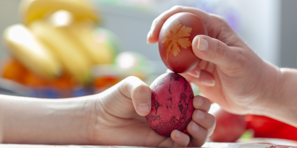 5 Easter Celebrations Around the Globe: Embracing Diversity and Tradition: This is an image of two hands holding differently patterned eggs, playing the egg cracking game.