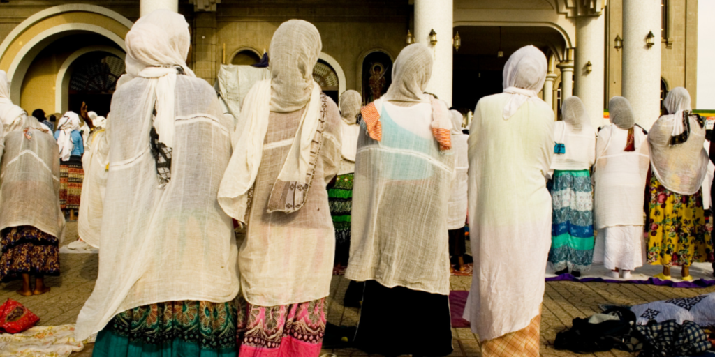 5 Easter Celebrations Around the Globe: Embracing Diversity and Tradition: This is an image of a line of women facing away, praying during Lent.
