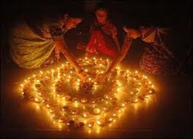 Three girls with candles in the dark: the light and shadows of Diwali